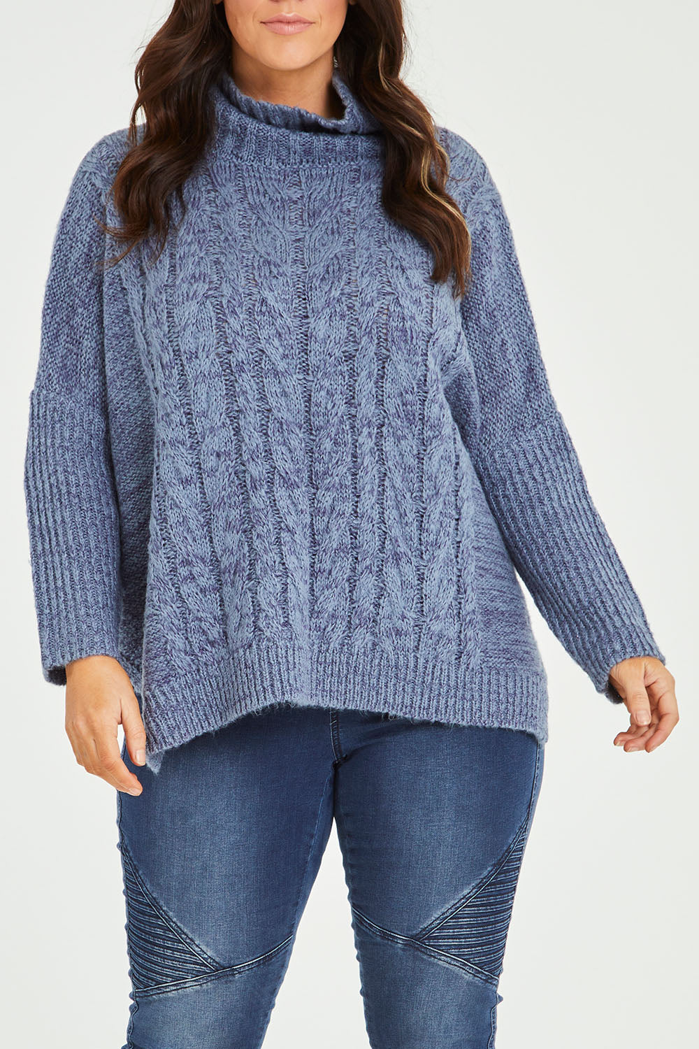 Model Laura wearing size M-L of the Cool Breeze Cable Sweater in colour Denim (Blue), from the front, cropped image