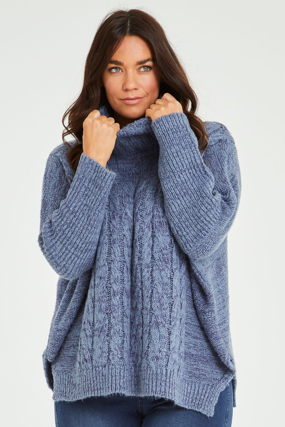 Model Laura wearing size M-L of the Cool Breeze Cable Sweater in colour Denim (Blue), from the front, cropped image