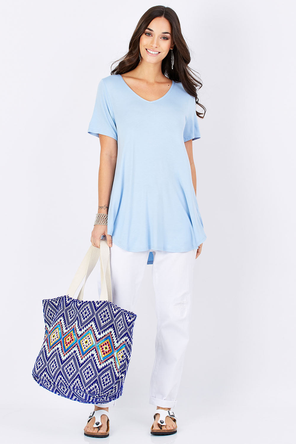 Model Georgia wearing size 10 of the Softly Swinging Bamboo Tee in colour Chambray (Blue), from the front, showing the whole outfit