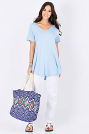 Model Georgia wearing size 10 of the Softly Swinging Bamboo Tee in colour Chambray (Blue), from the front, showing the whole outfit
