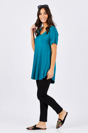 Model Georgia wearing size 10 of the Softly Swinging Bamboo Tee in colour Jewel (Green), from the front, showing the whole outfit