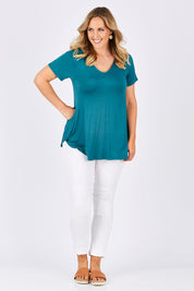 Model Jess wearing size 14 of the Softly Swinging Bamboo Tee in colour Jewel (Green), from the front, showing the whole outfit