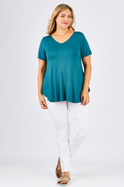 Model Ljubenka wearing size 18 of the Softly Swinging Bamboo Tee in colour Jewel (Green), from the front, showing the whole outfit