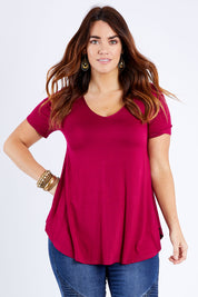 Model Laura wearing size 14 of the Softly Swinging Bamboo Tee in colour Ruby (Red), from the front, cropped image