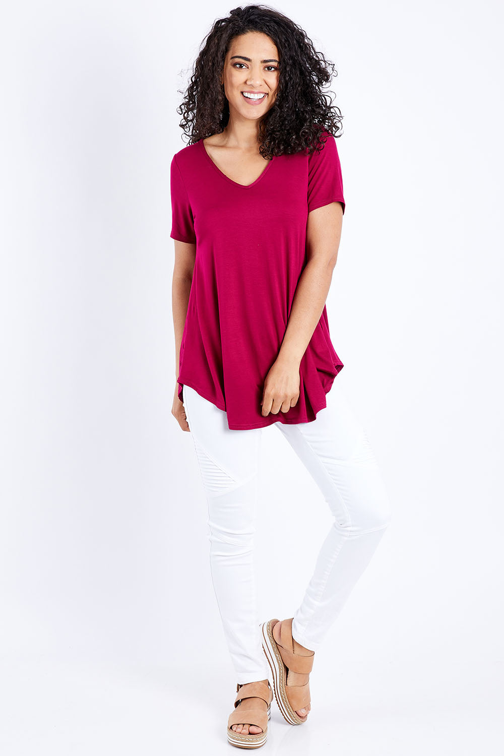 Model Pamela wearing size 10 of the Softly Swinging Bamboo Tee in colour Ruby (Red), from the front, showing the whole outfit