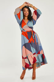 Model Noli wearing size 14 of the La Dolce Vita Print Wrap Dress in colour Geoblue (Blue), from the front, showing the whole outfit