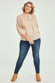 Model Fiona wearing size 16 of the Delighted To Meet You Blouse in colour Sand, from the front, showing the whole outfit