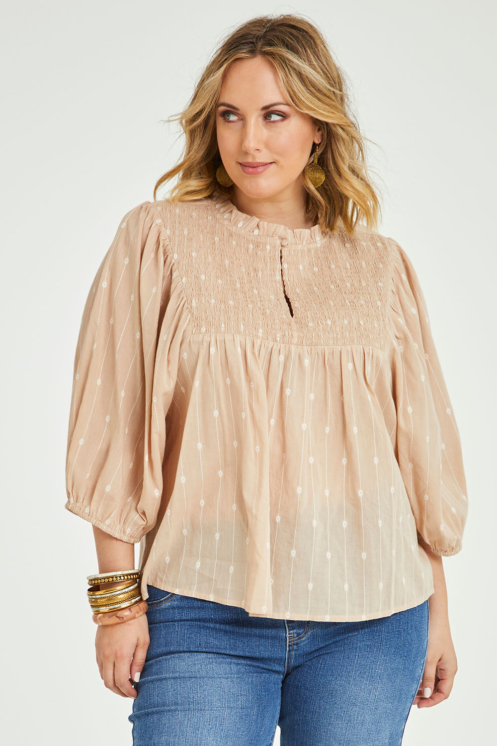 Model Jess wearing size 14 of the Delighted To Meet You Blouse in colour Sand, from the front, cropped image