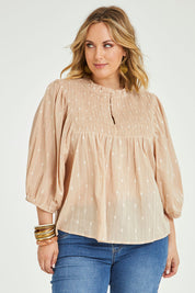 Model Jess wearing size 14 of the Delighted To Meet You Blouse in colour Sand, from the front, cropped image