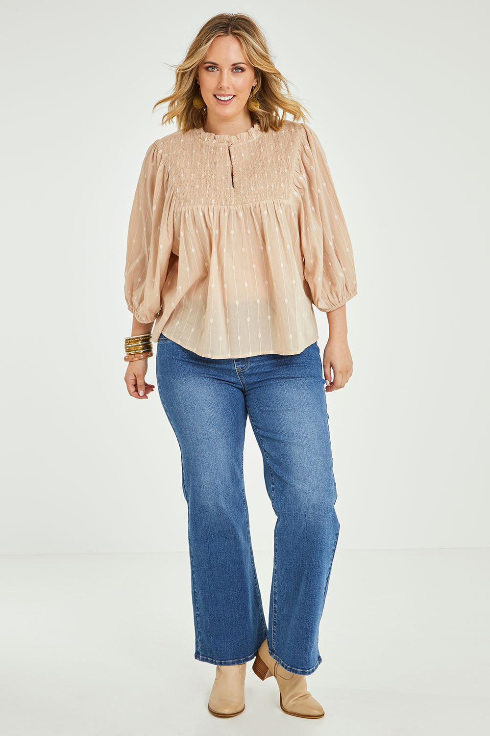 Model Jess wearing size 14 of the Delighted To Meet You Blouse in colour Sand, from the front, showing the whole outfit