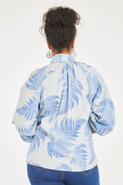 Model Noli wearing size 14 of the Fern Fair Cotton Blouse in colour Bluefern (Blue), from the back