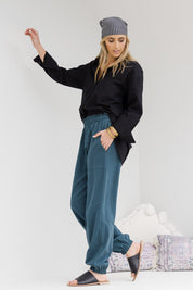 Model Tegan wearing size 10 of the Dawn Break Relaxed Pants in colour Ocean (Blue), from the front, showing the whole outfit