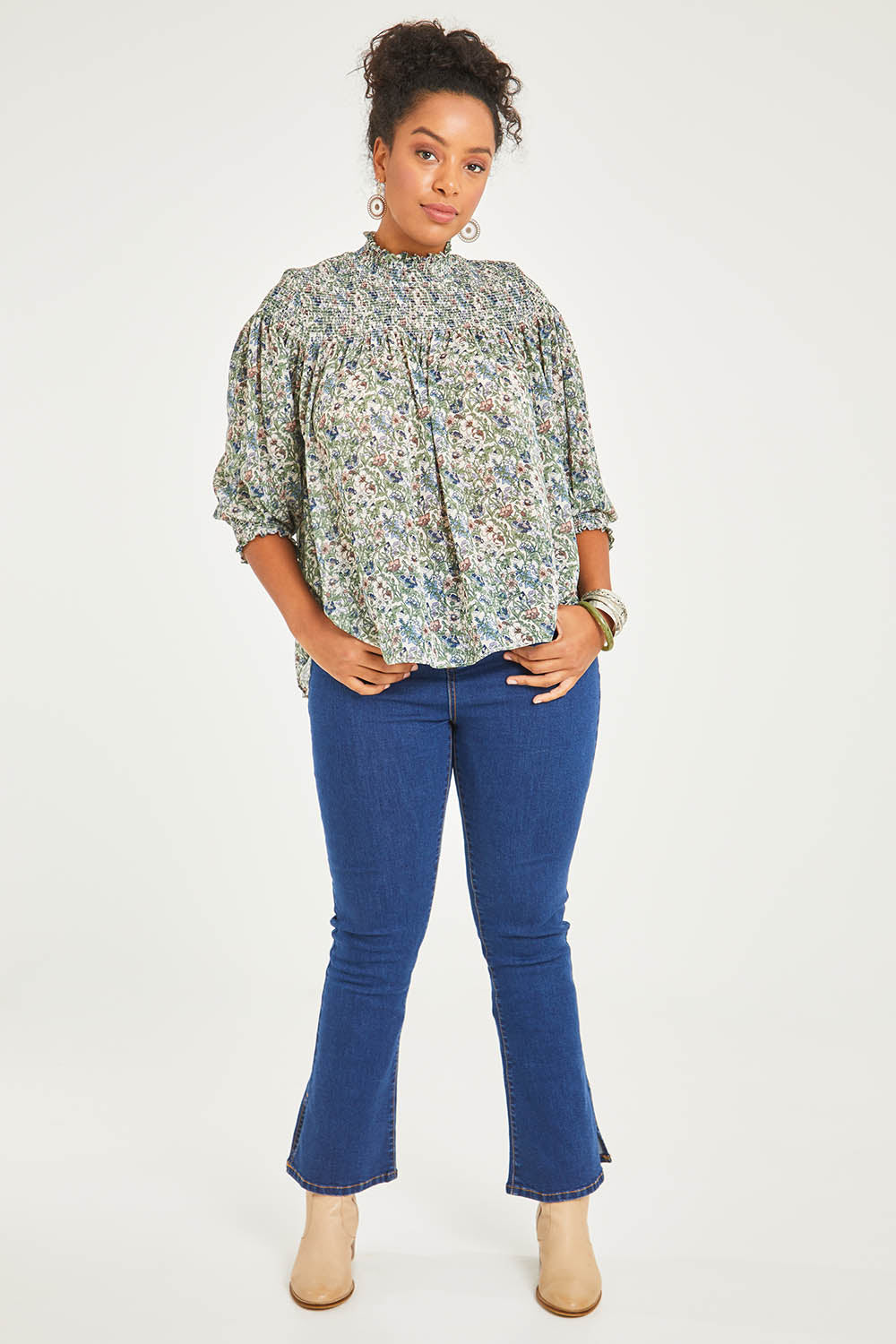 Model Noli wearing size 14 of the Romance In The Air Blouse in colour Fleur (Green), from the front, showing the whole outfit