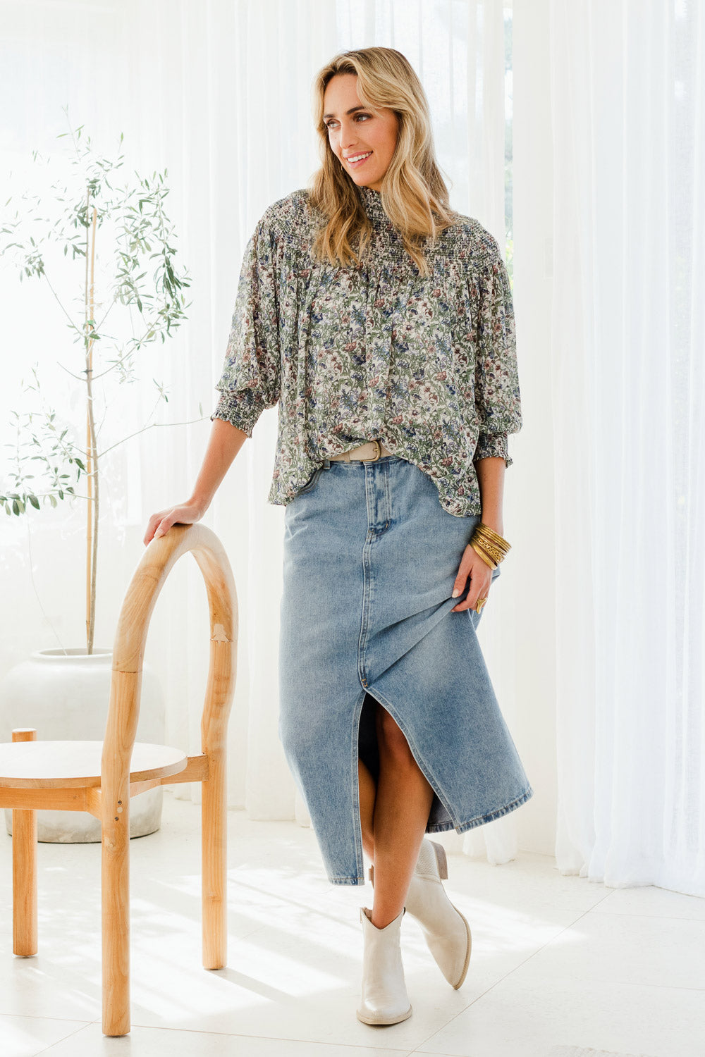 Model Tegan wearing size 10 of the Romance In The Air Blouse in colour Fleur (Green), from the front, showing the whole outfit