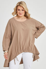 Model Keeara wearing size 16 of the Good Times Gather Top in colour Latte, from the front, cropped image