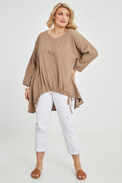 Model Keeara wearing size 16 of the Good Times Gather Top in colour Latte, from the front, showing the whole outfit