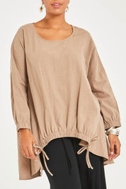 Model Noli wearing size 14 of the Good Times Gather Top in colour Latte, from the front, cropped image