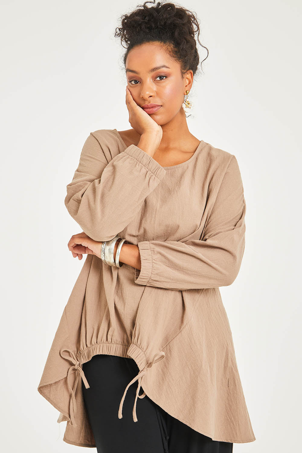Model Noli wearing size 14 of the Good Times Gather Top in colour Latte, from the front, cropped image