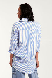 Model Natalie wearing size 10 of the Relaxed Elegance Boyfriend Shirt in colour Bluestripe (Blue), from the front, cropped image