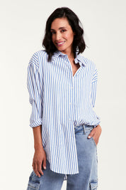 Model Natalie wearing size 10 of the Relaxed Elegance Boyfriend Shirt in colour Bluestripe (Blue), from the front, cropped image