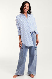 Model Natalie wearing size 10 of the Relaxed Elegance Boyfriend Shirt in colour Bluestripe (Blue), from the front, showing the whole outfit