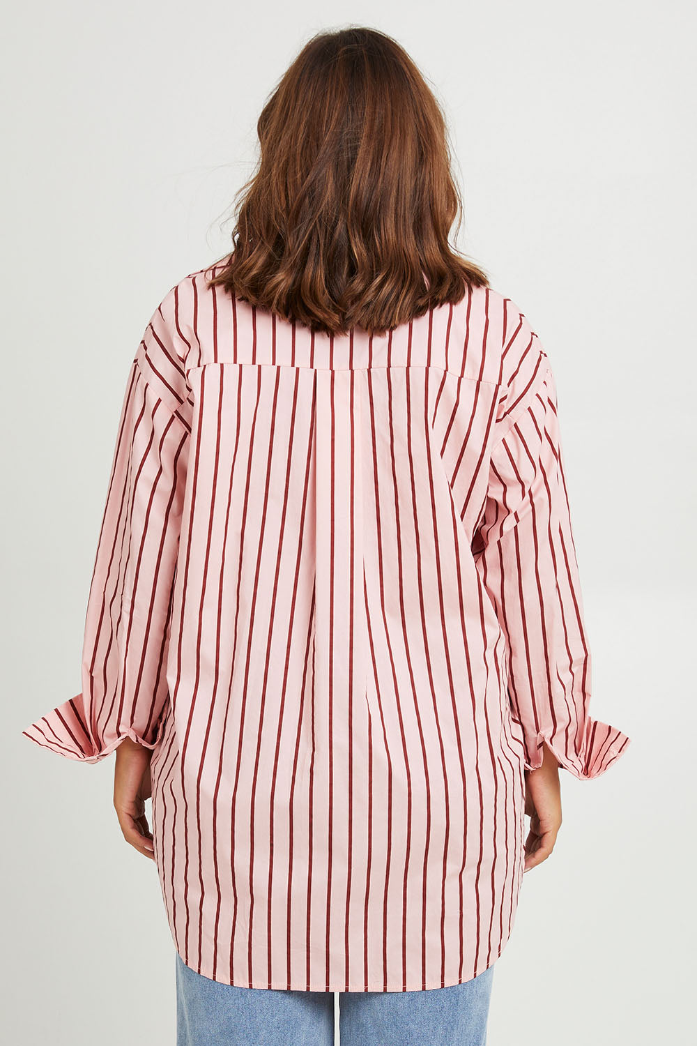 Model Monique wearing size 14 of the Relaxed Elegance Boyfriend Shirt in colour Pinkstripe (Pink), from the back