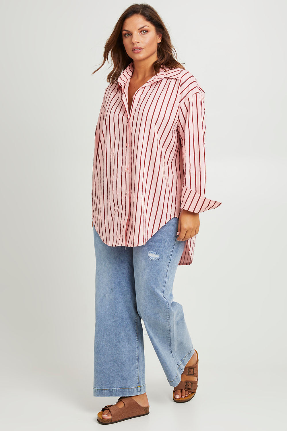 Model Monique wearing size 14 of the Relaxed Elegance Boyfriend Shirt in colour Pinkstripe (Pink), from the front, showing the whole outfit