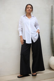 Model Tahnee wearing size 10 of the Relaxed Elegance Boyfriend Shirt in colour White (White), from the front, showing the whole outfit
