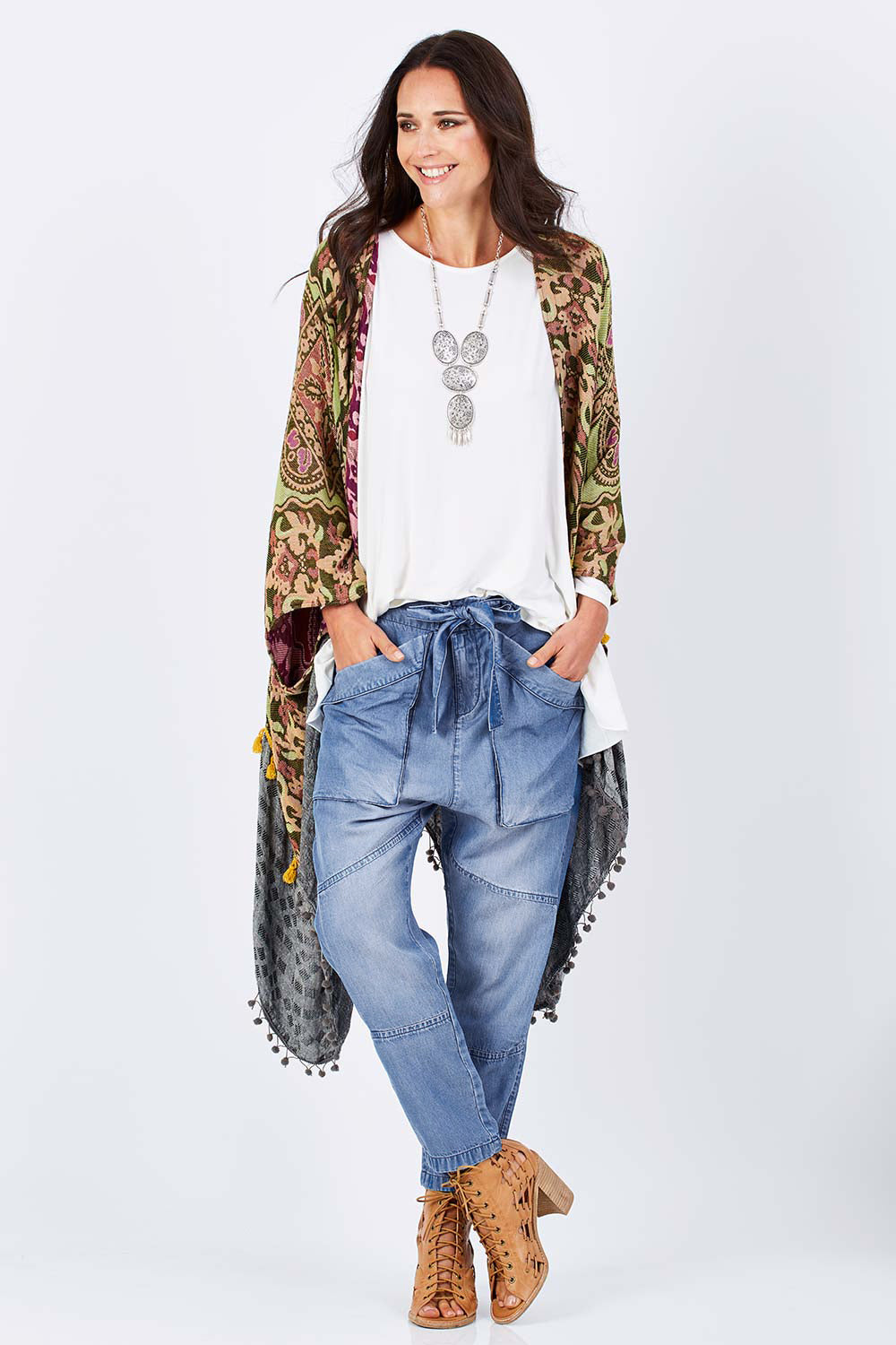 Model Clementine wearing size 10 of the With My Tribe Pants in colour Denim (Blue), from the front, showing the whole outfit