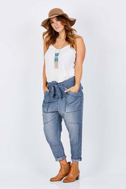 Model Laura wearing size 14 of the With My Tribe Pants in colour Denim (Blue), from the front, showing the whole outfit
