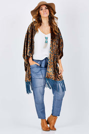 Model Laura wearing size 14 of the With My Tribe Pants in colour Denim (Blue), from the front, showing the whole outfit