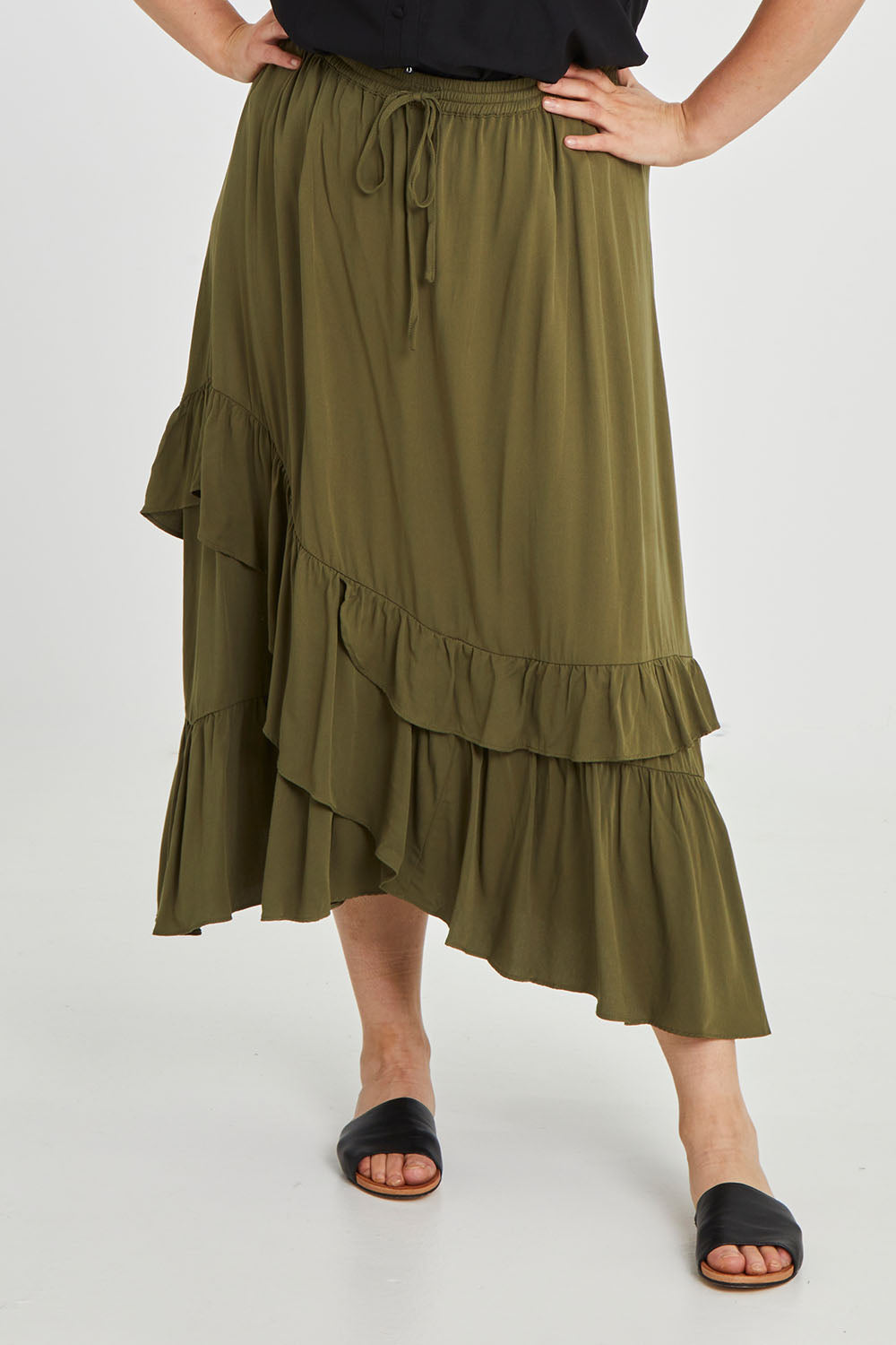 Model Keeara wearing size 16 of the Day To Night Flounce Skirt in colour Khaki (Green), from the front, cropped image