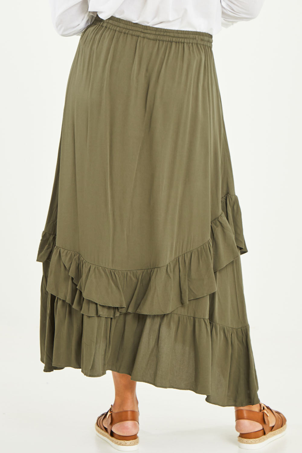 Model Noli wearing size 14 of the Day To Night Flounce Skirt in colour Khaki (Green), from the back
