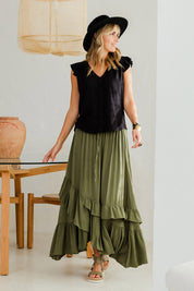 Model Tegan wearing size 10 of the Day To Night Flounce Skirt in colour Khaki (Green), from the front, showing the whole outfit