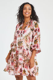 Model Noli wearing size 14 of the Down The Garden Path Dress in colour Fleur (Pink), from the front, cropped image