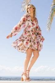 Model Tegan wearing size 10 of the Down The Garden Path Dress in colour Fleur (Pink), from the front, showing the whole outfit