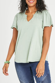 Model Noli wearing size 14 of the Shirred Butterfly Sleeve Tee in colour Sage (Green), from the front, cropped image