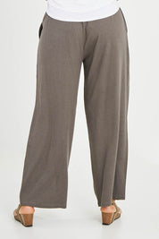 Model Noli wearing size 14 of the Can Do It All Pants in colour Concrete (Grey), from the back