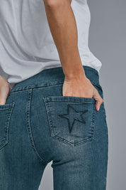Model Alice wearing size 10 of the Wild Plains Flat Front Stitch Jeggings in colour Darkdenim (Blue), from the front, cropped image