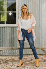 Model Tegan wearing size 10 of the Wild Plains Flat Front Stitch Jeggings in colour Darkdenim (Blue), from the front, showing the whole outfit