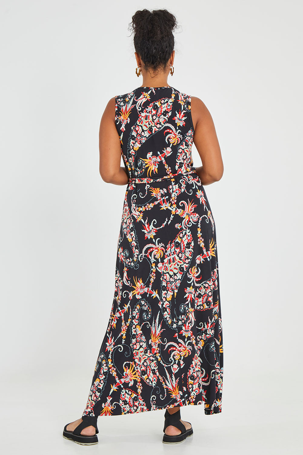 Model Noli wearing size 14 of the Life Is Beautiful Sleeveless Wrap Maxi in colour Blkpaisley (Black), from the back