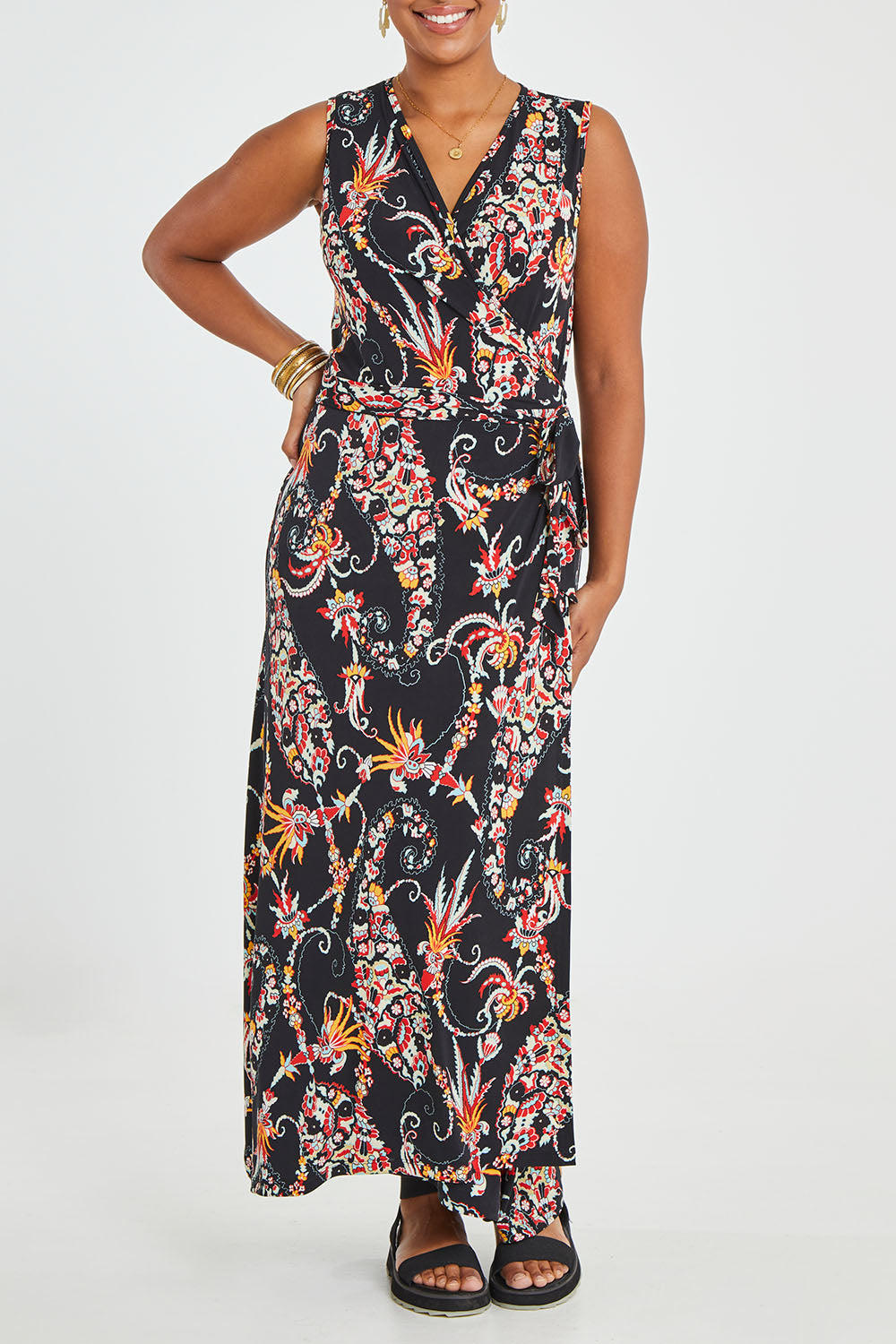 Model Noli wearing size 14 of the Life Is Beautiful Sleeveless Wrap Maxi in colour Blkpaisley (Black), from the front, cropped image