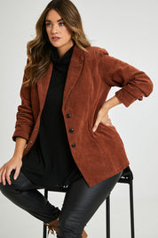 Model Laura wearing size 14 of the Feeling Good Cord Blazer in colour Rust, from the front, cropped image
