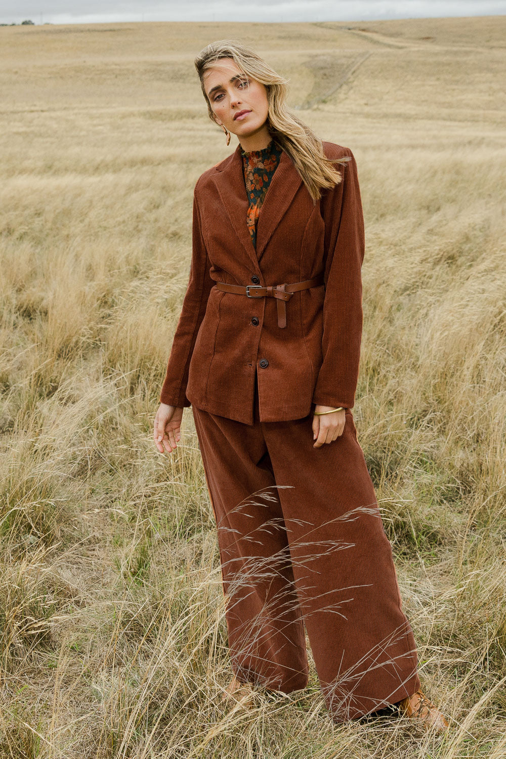 Model Tegan wearing size 10 of the Feeling Good Cord Blazer in colour Rust, from the front, showing the whole outfit