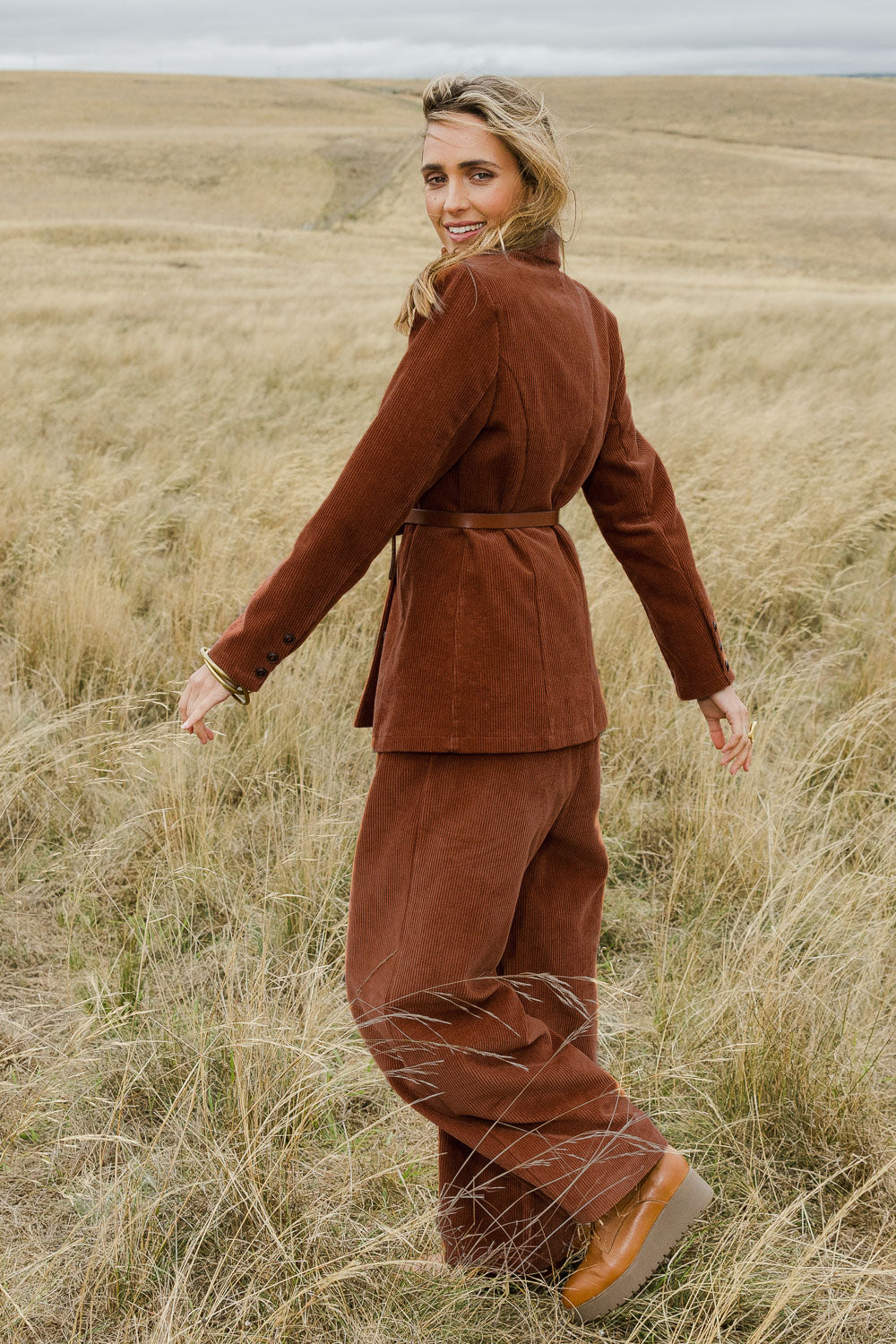 Model Tegan wearing size 10 of the Feeling Good Cord Blazer in colour Rust, from the front, showing the whole outfit