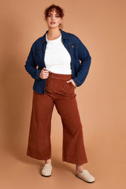 Model Maddy wearing size 16 of the Feeling Good Wide Leg Cord Pants in colour Rust, from the front, showing the whole outfit