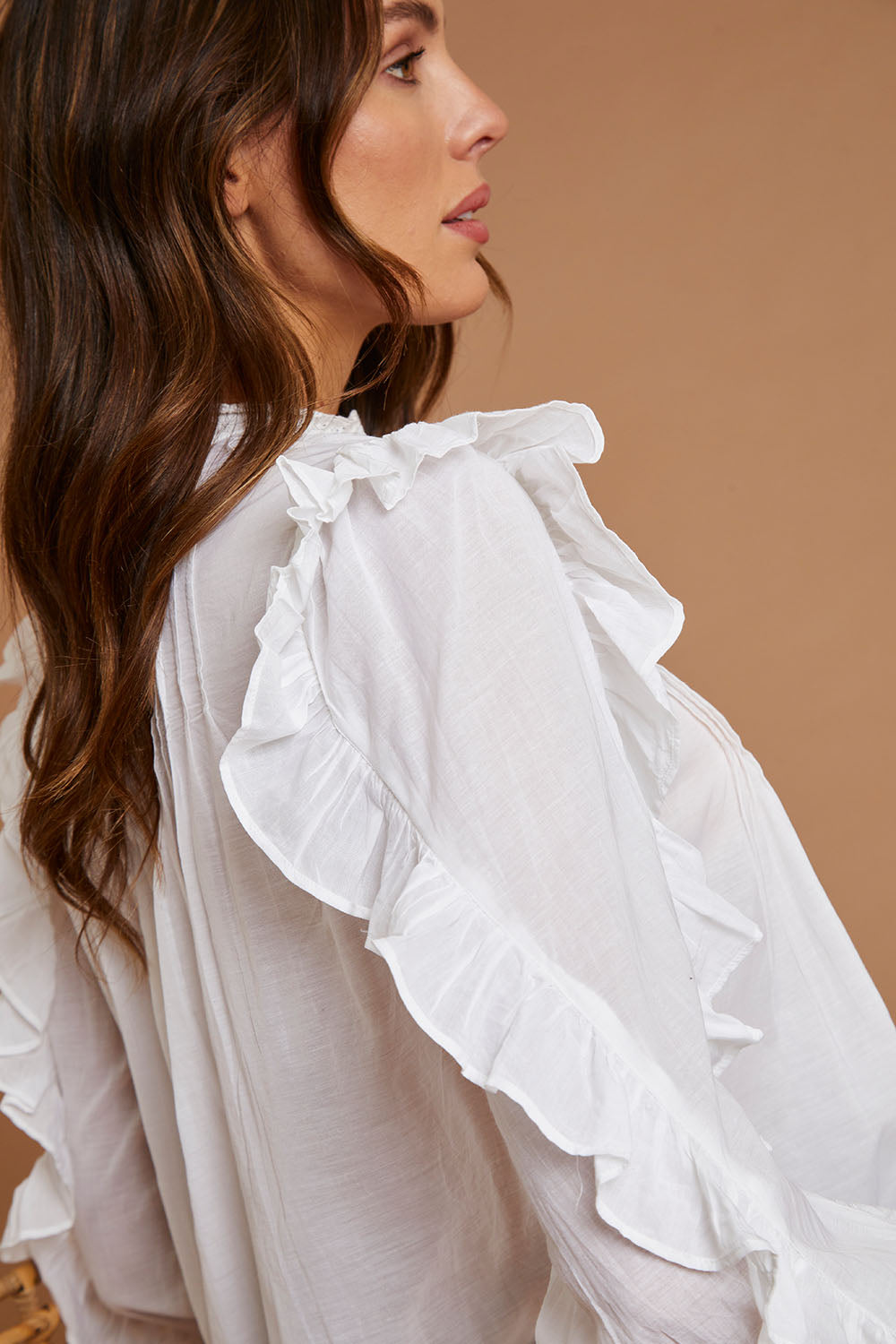 Model Madeline wearing size 10 of the Ruffled Feathers Blouse in colour White (White), from the front, cropped image