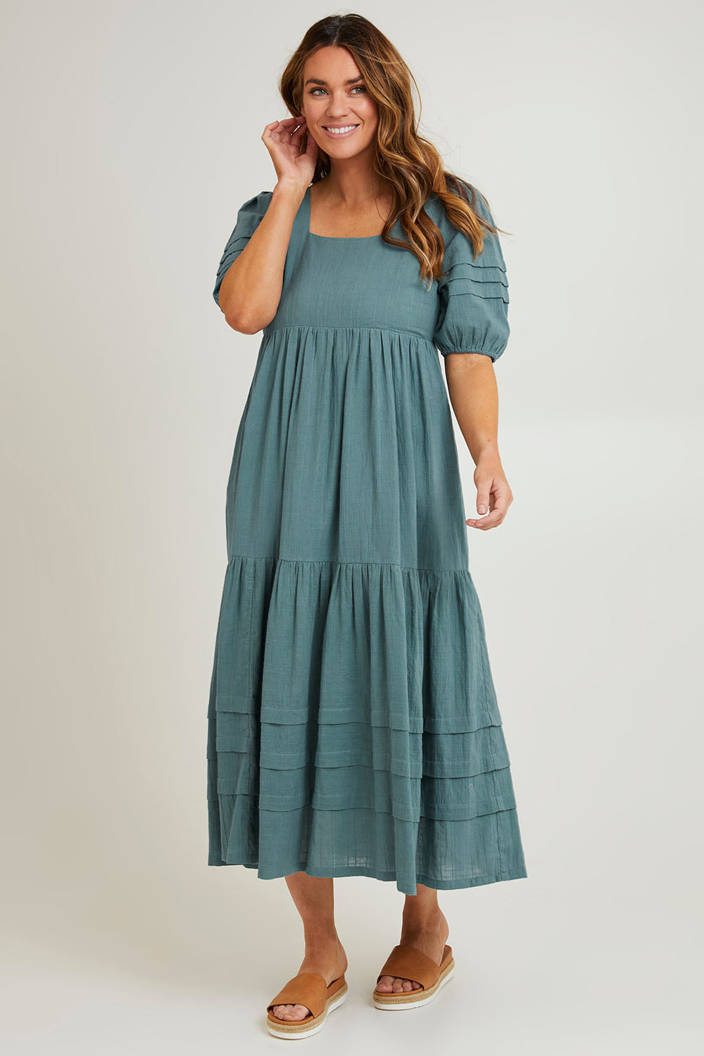 Model Laura wearing size 14 of the Chasing Butterflies Cotton Dress in colour Sage (Green), from the front, showing the whole outfit