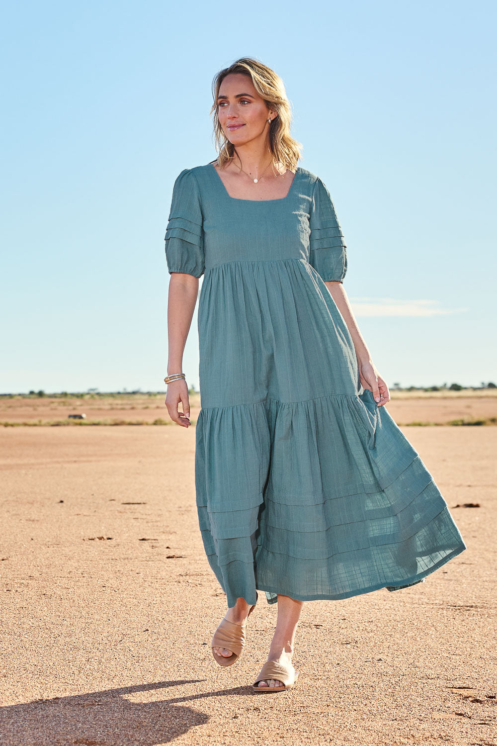 Model Tegan wearing size 10 of the Chasing Butterflies Cotton Dress in colour Sage (Green), from the front, showing the whole outfit