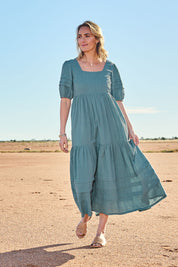 Model Tegan wearing size 10 of the Chasing Butterflies Cotton Dress in colour Sage (Green), from the front, showing the whole outfit